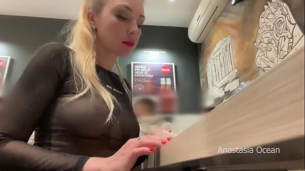 Flashing her big boobs in transparent top in public cafe.